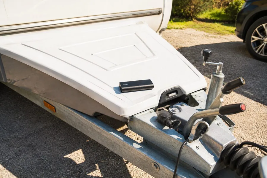 GPS Tracker Pro Max lying on the hitch cover of a caravan