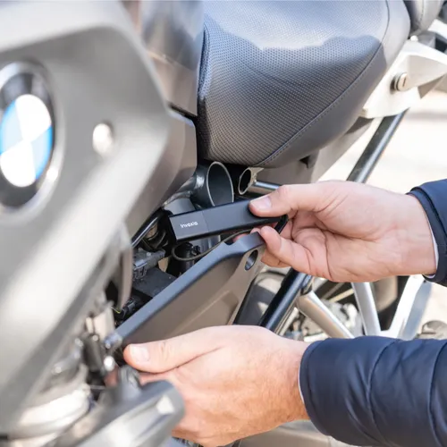 a person placing a Tracker GPS Pro on their motorcycle