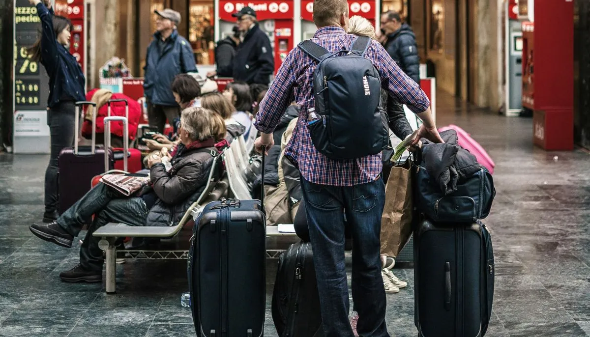 Travelers waiting with their suitcases