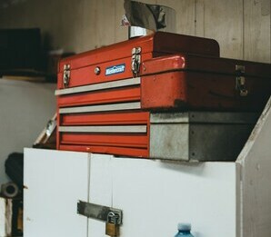 Red toolbox placed on a piece of furniture